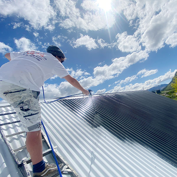 davis decor team painting a roof in queenstown
